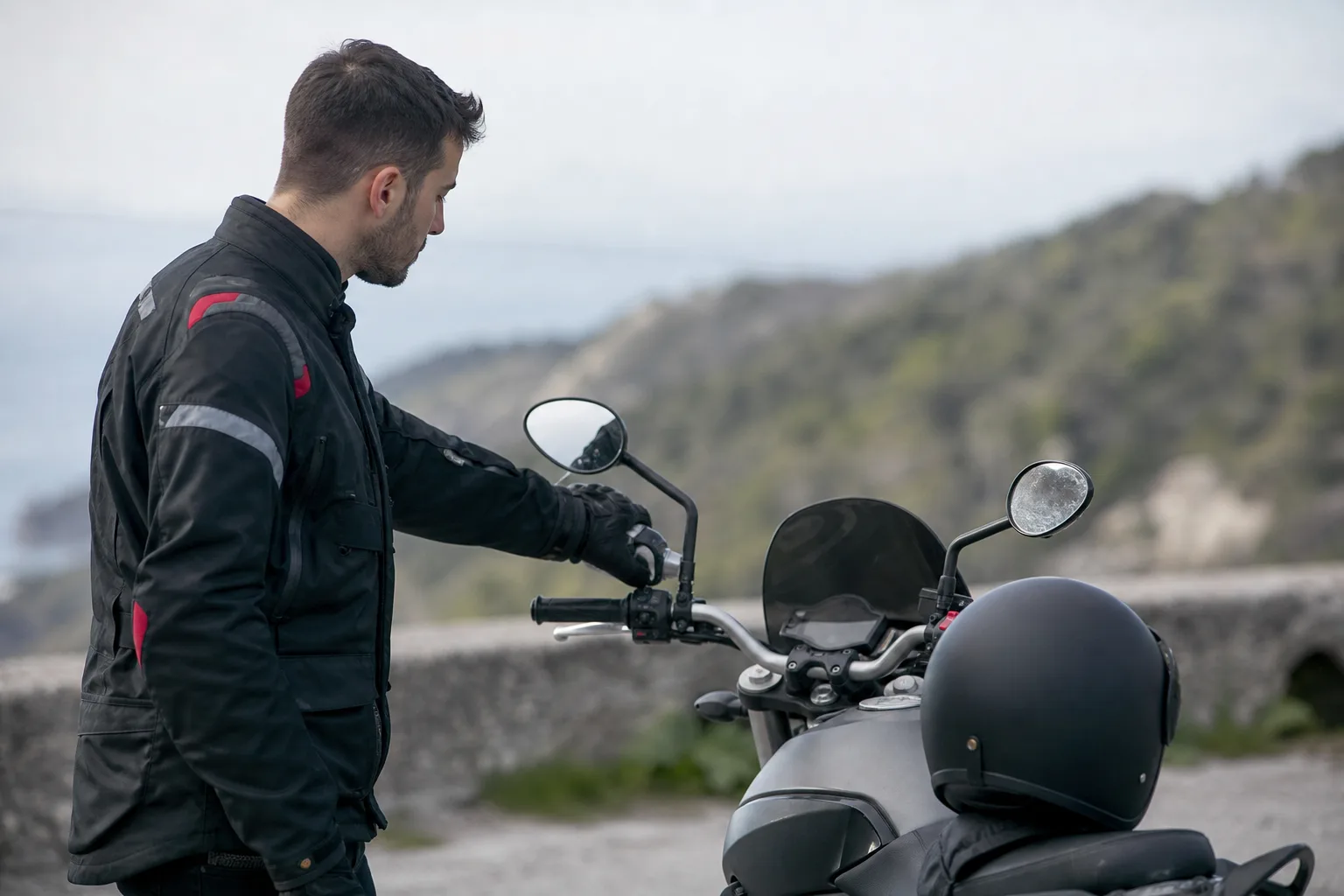 Rider checking motorcycle controls during a pre-ride scan.